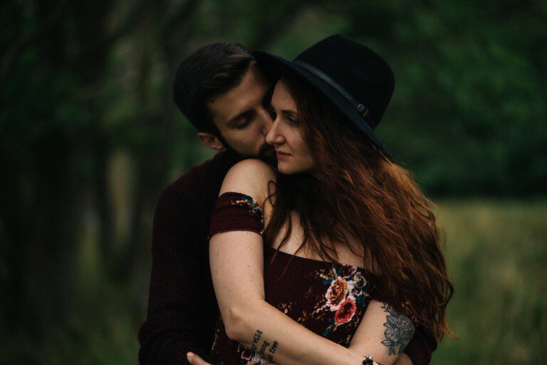 couple embracing with hat