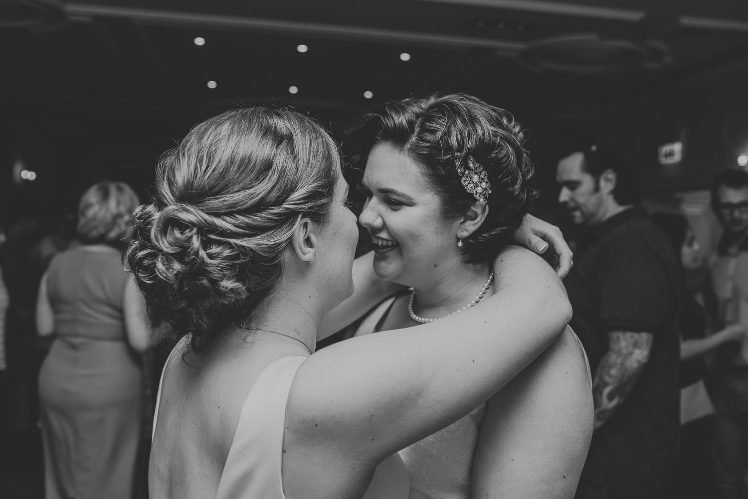 brides hugging on the dance floor