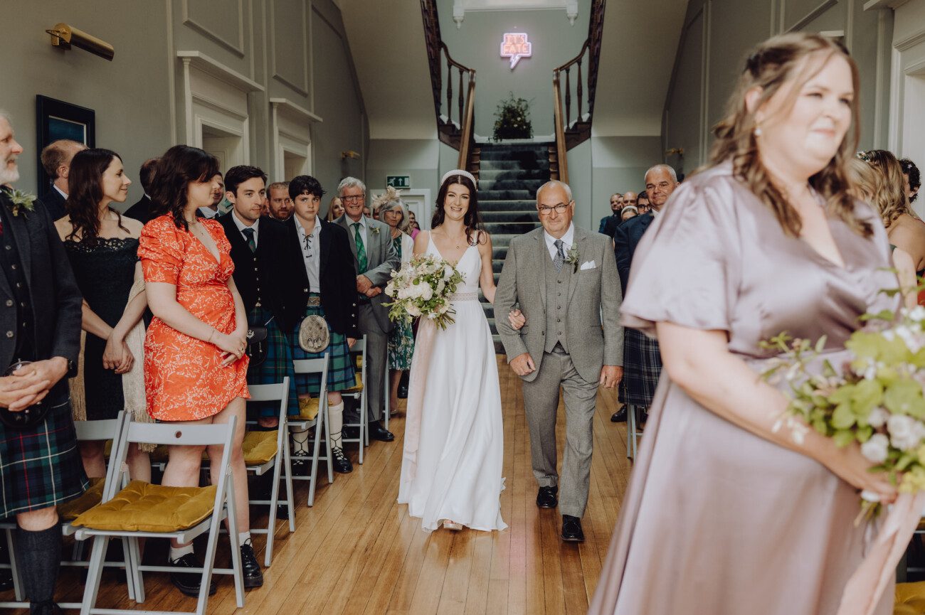Bride being walked down the aisle