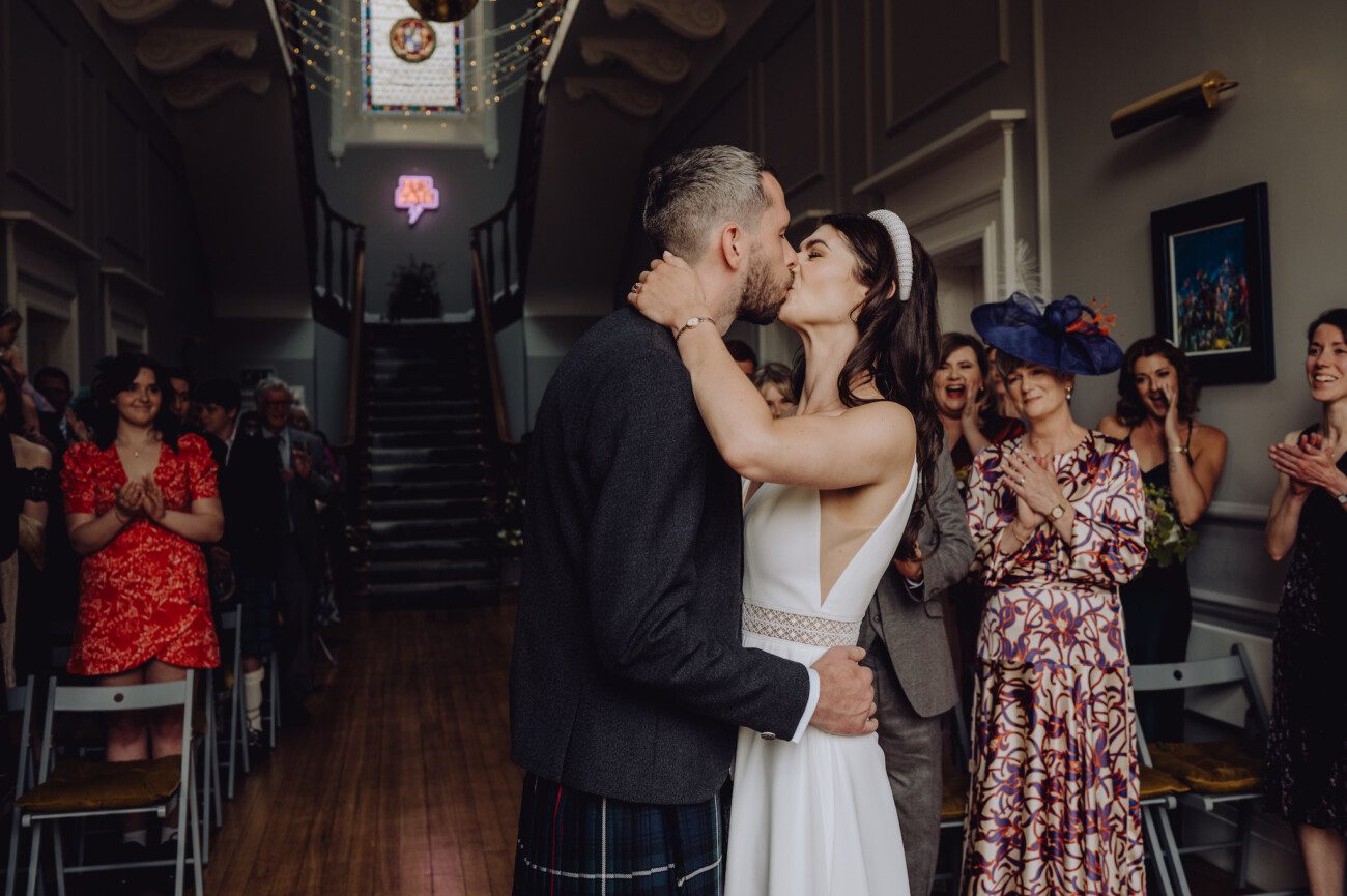 Bride and groom share first kiss