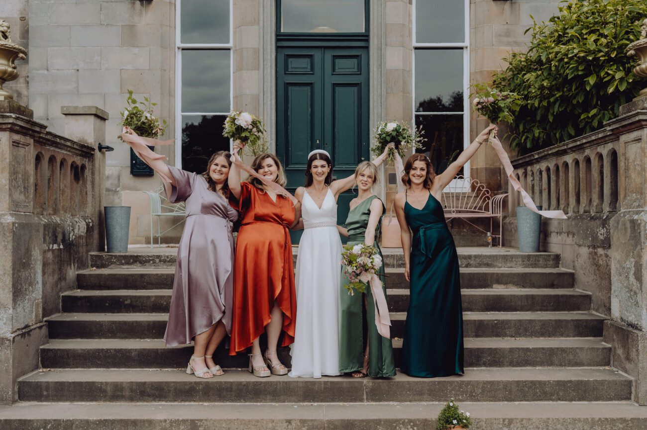 Bride and bridesmaids on front steps of Netherbyres House