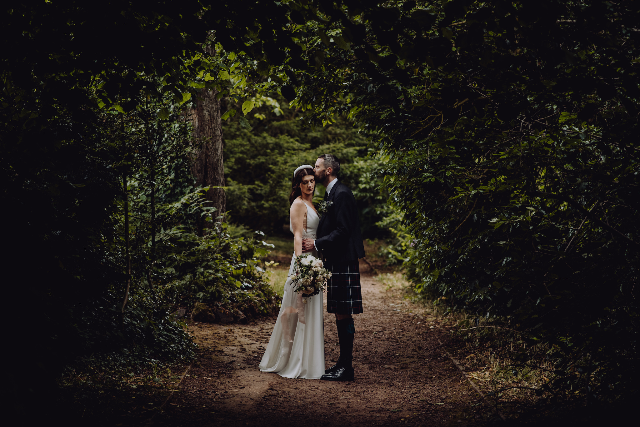 Bride and groom in a wooded area