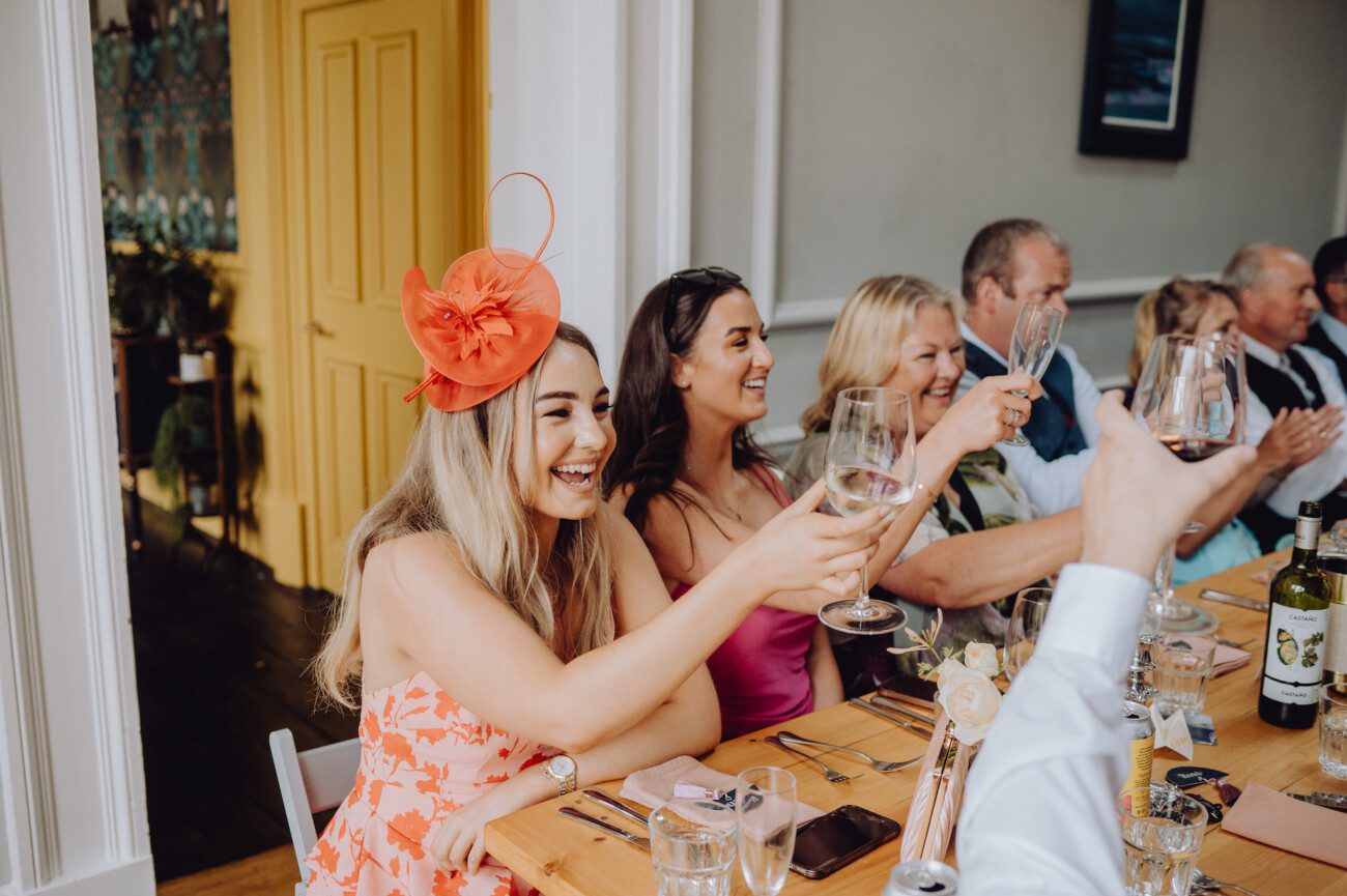 Wedding guests toasting to the couple