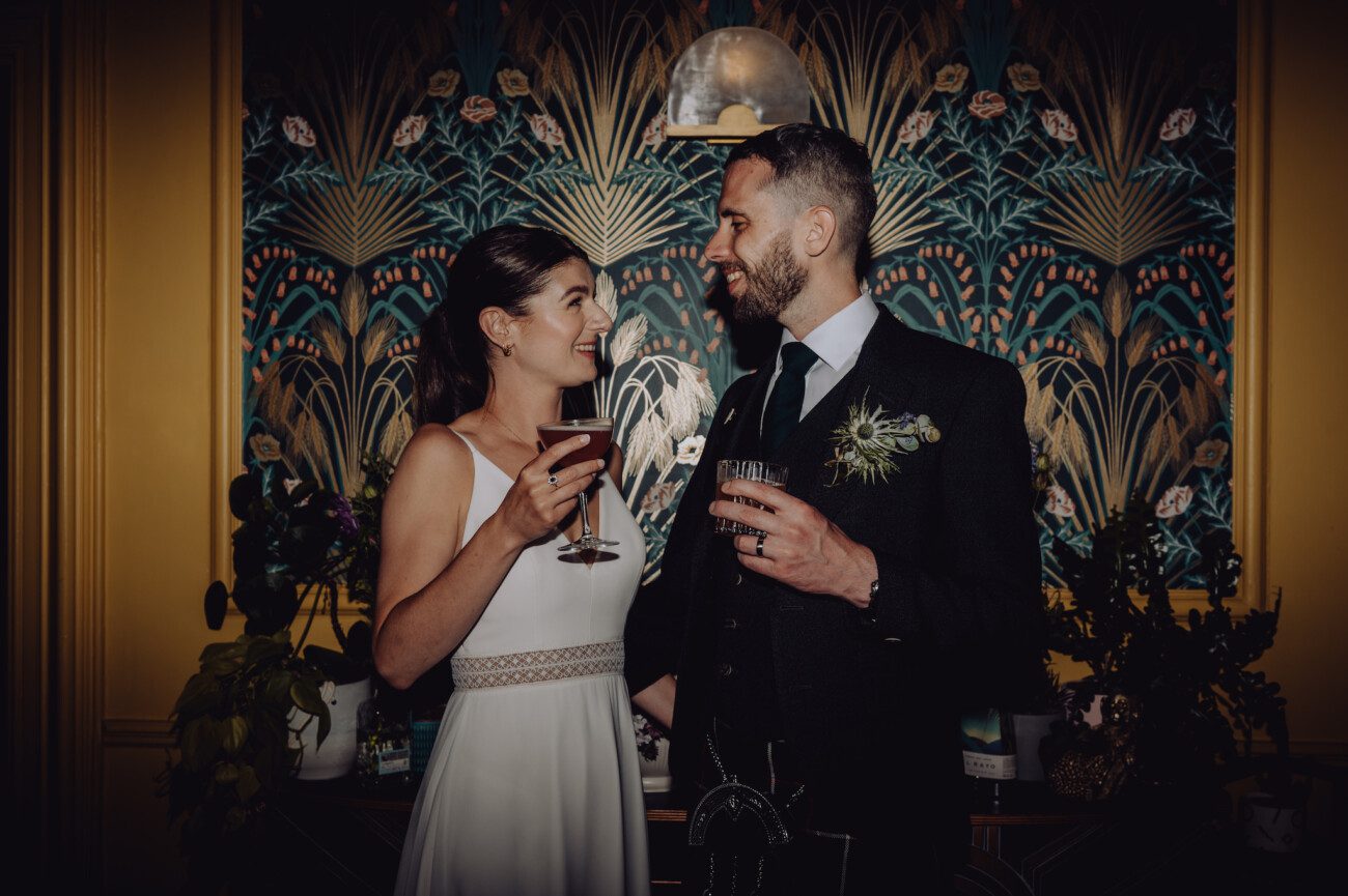 Bride and groom drinking cocktails