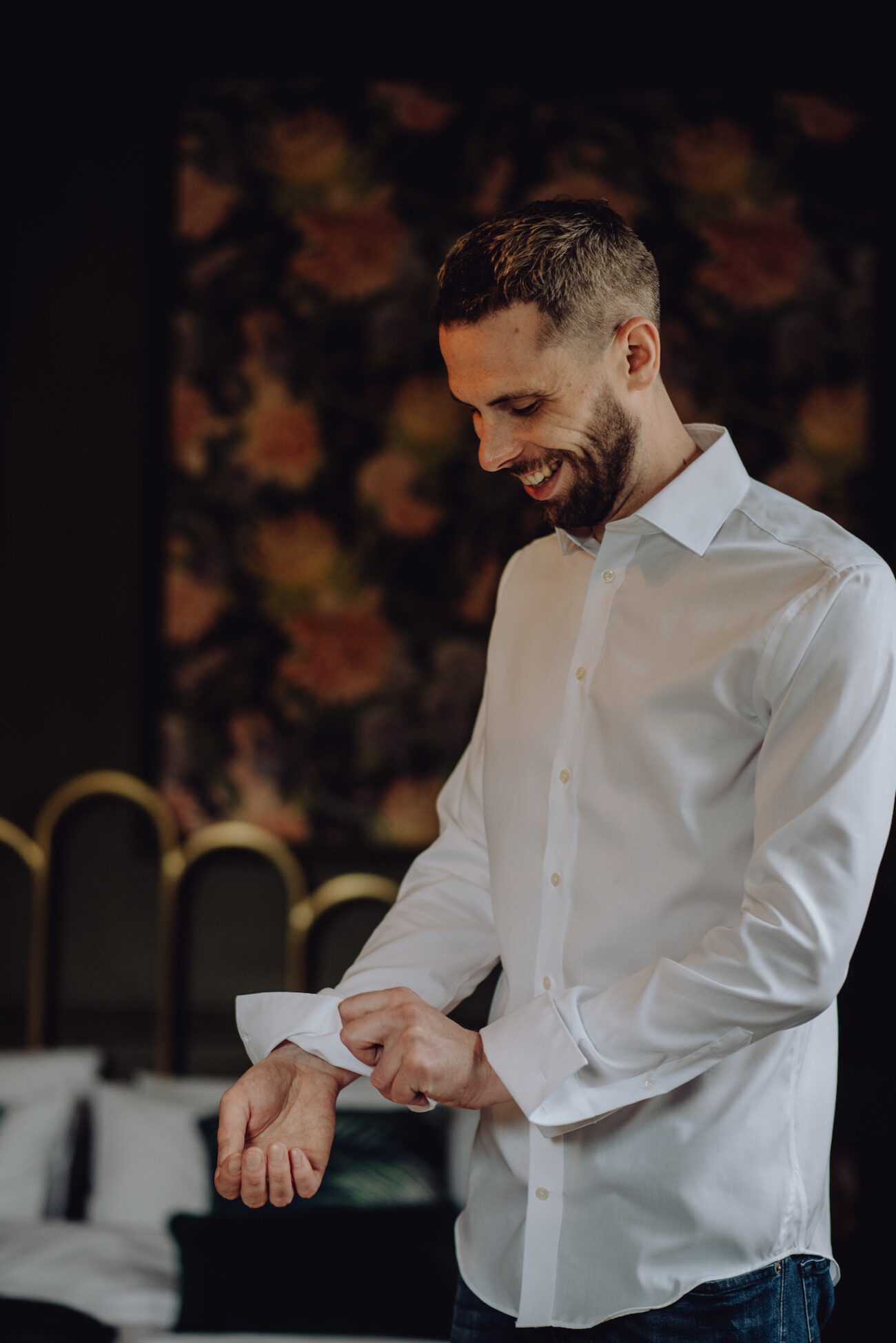 Groom adjusting his shirt cuffs