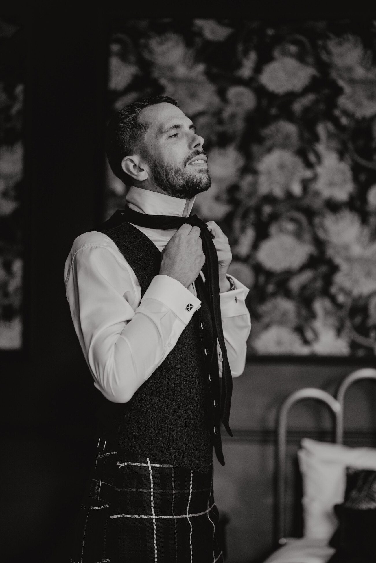 Groom putting on his tie