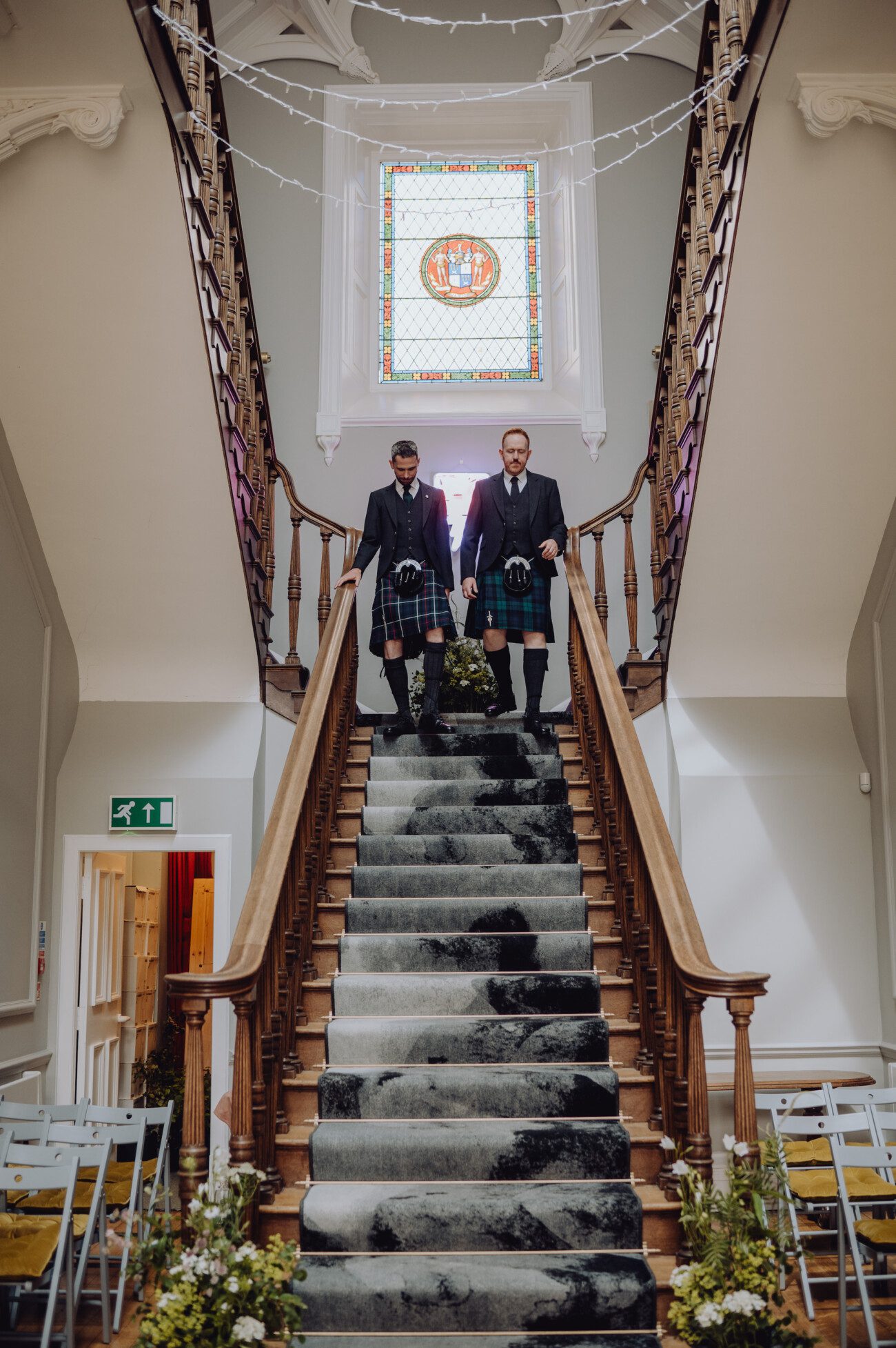 Groom and best man walking down stairs