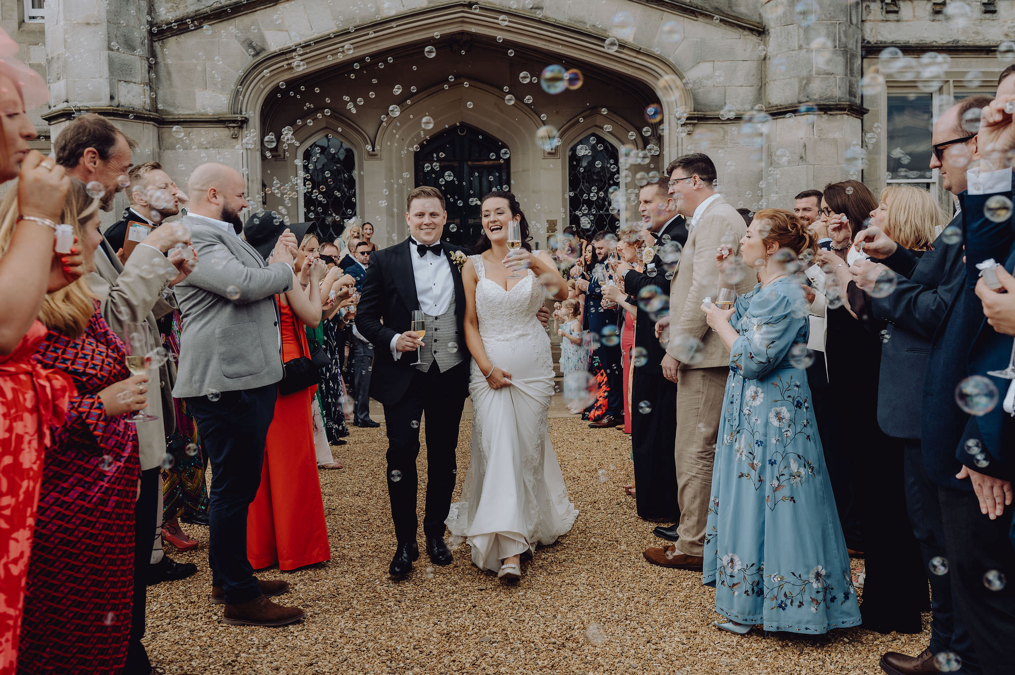 Couple exiting castle through bubble parade